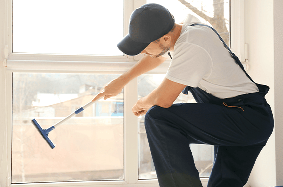 Worker Cleaning Windows