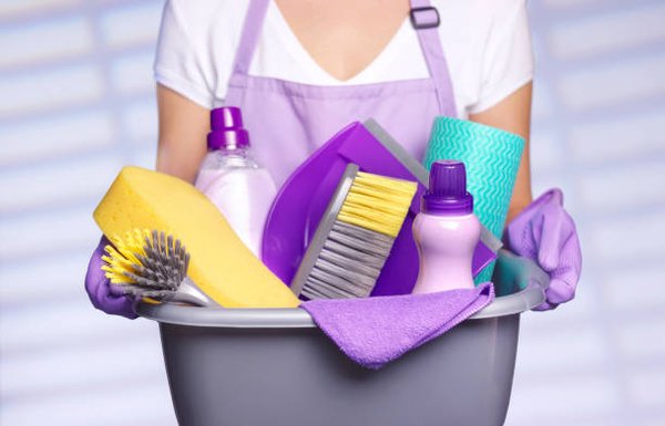 Woman Holding A Bucket Filled With Cleaning Supplies